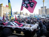 Mikhail Zhiznevsky’s coffin is paraded through the protest, draped in the flag of his paramilitary nazi group. Pic credit: Getty Images