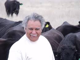 Michael with a special breed of cattle on the farm he manages for his extended family