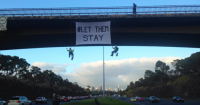Two women unfurled a 'Let Them Stay' banner from a bridge over Melbourne's Eastern Freeway (photo from the Whistleblowers, Activists and Citizens Alliance Twitter account). 