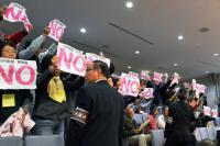 Anti-nuclear group members protest against the Kagoshima prefectural assembly's vote to restart the Sendai plant.