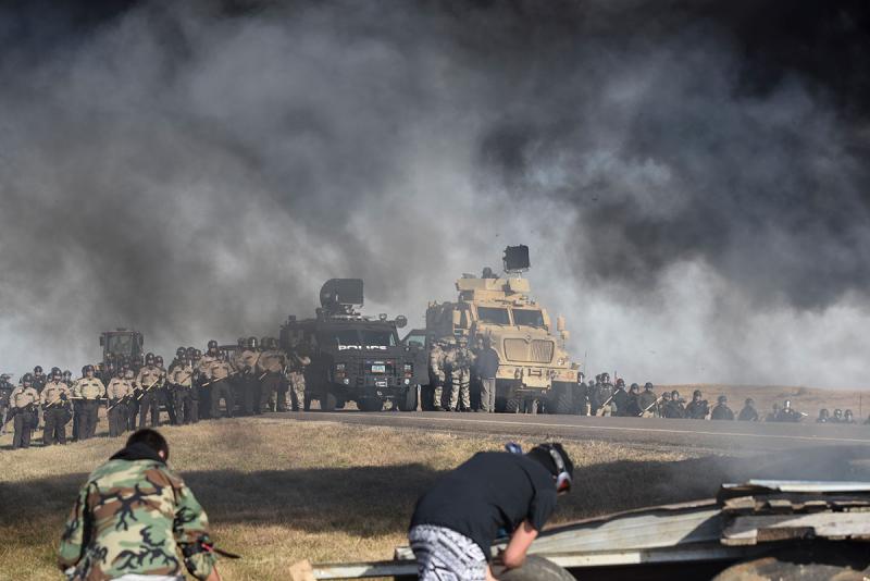 Heavily armed police march on a camp where Native Americans prevented construction of an oil pipeline.