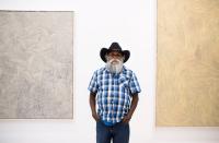  Warlimpirrnga Tjapaltjarri with two of his untitled paintings at Salon 94