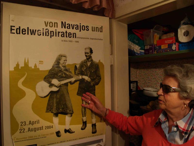 Mucki präsentiert ein Plakat, das sie als Jugendliche zeigt(Foto: Azzoncao)